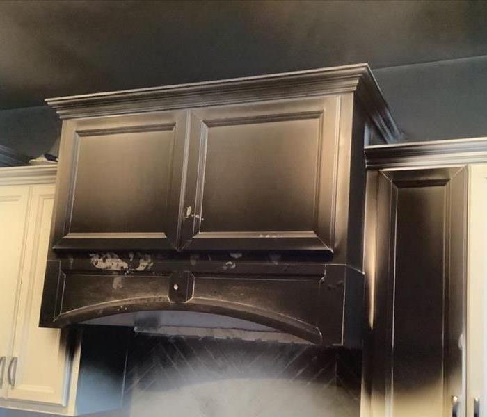 white kitchen cabinet covered in smoke